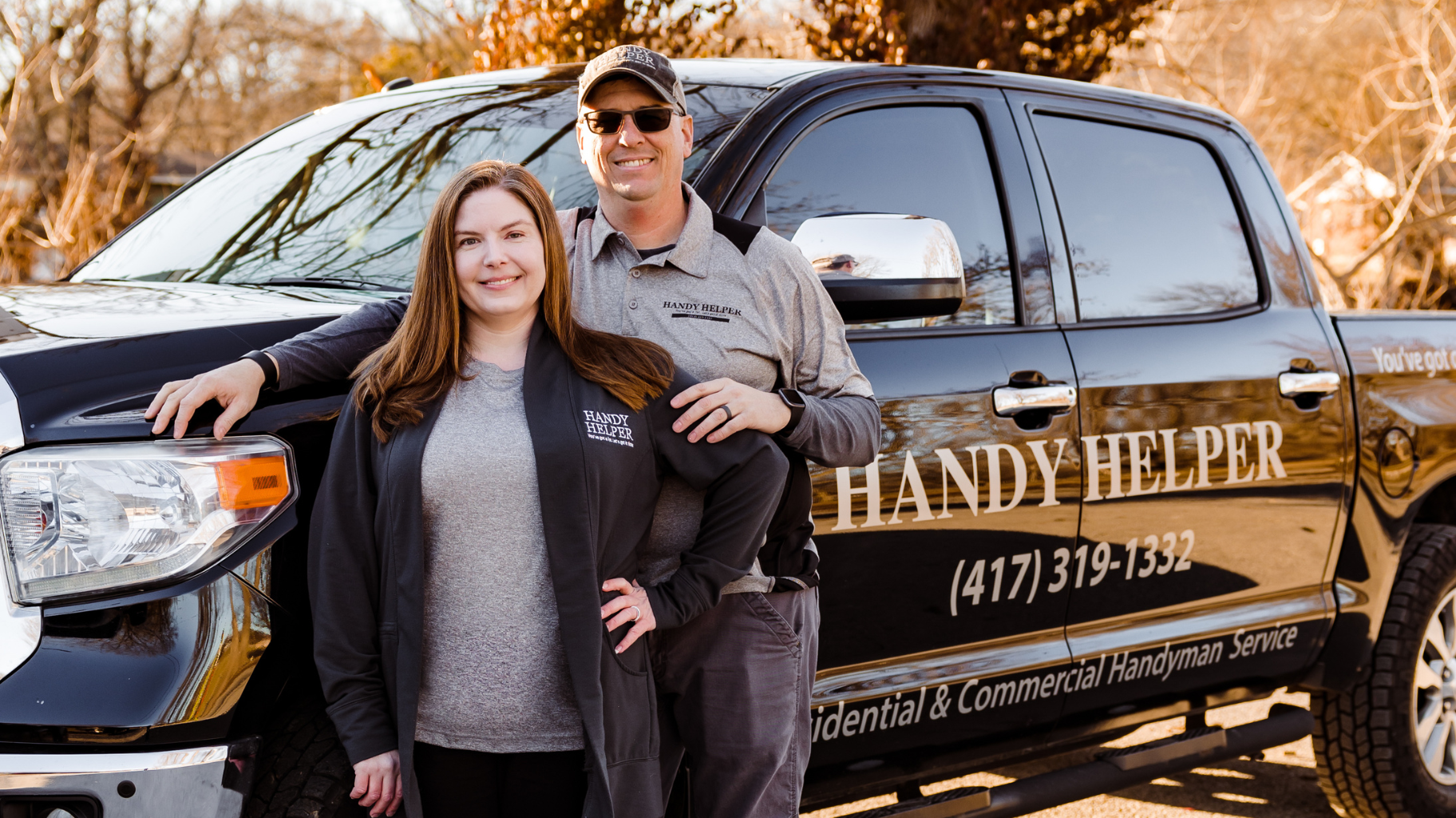 Tim and Stacey standing in front of the Handy Helper truck